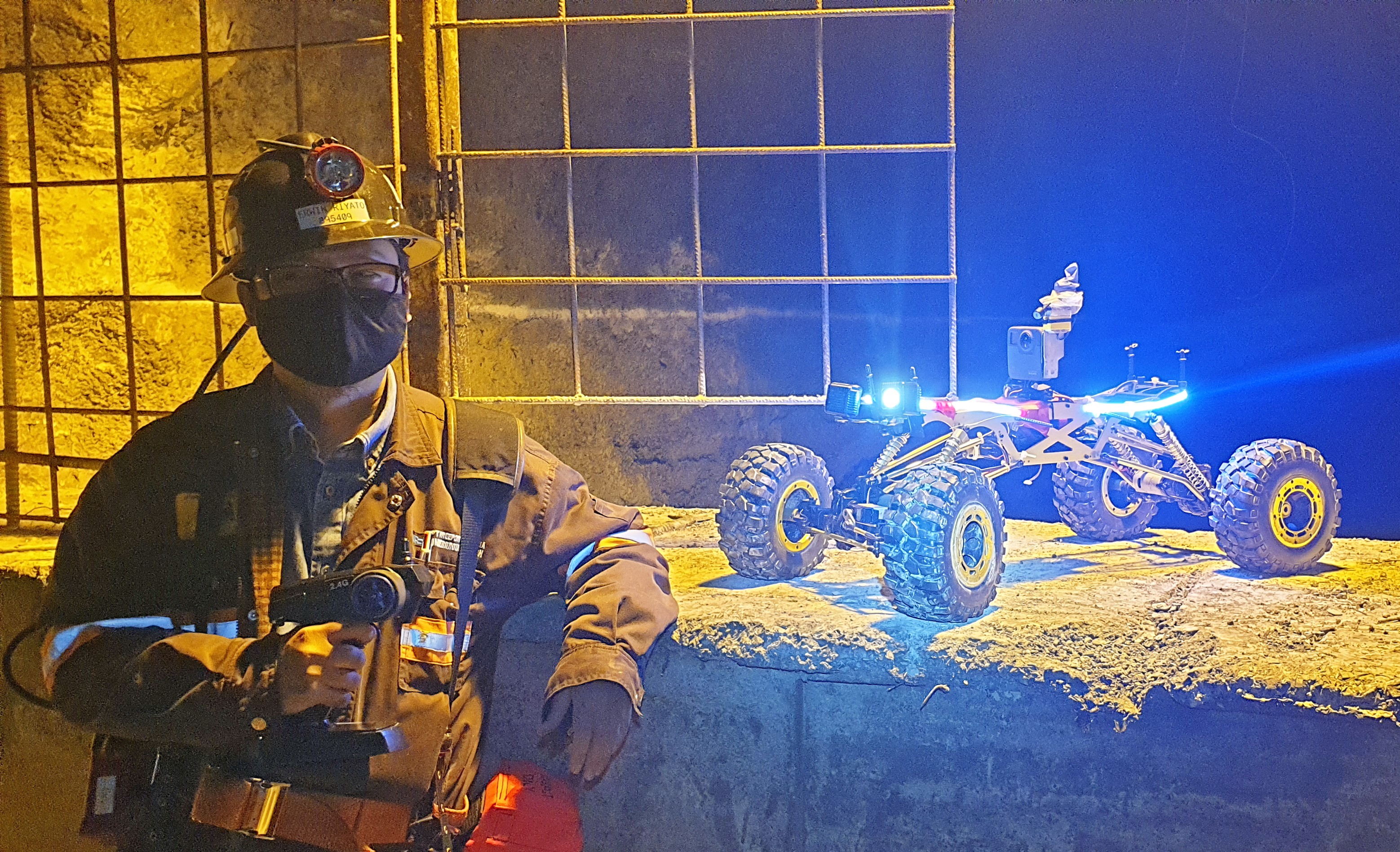 Erwin Riyanto, General Superintendent-Underground Monitoring at PTFI, poses with the remote-control crawler just before sending it down a tunnel at the Grasberg Block Cave mine.
