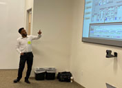During his final presentation at the Phoenix Collaboration Hub, intern Biya Yebassa explains the work he did to redesign the interface screen used to monitor water pumps at the Henderson mine.