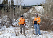 Geoff Niggeler and Kasey Martin stand in an area cleared of vegetation for fire protection.