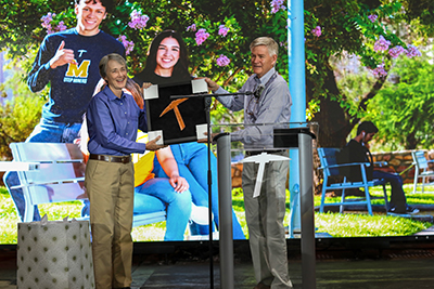 Mike Kendrick (right) presents UTEP President Heather Wilson with a copper pickaxe during a ceremony in El Paso.