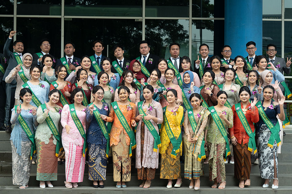 Dr. Sephia Chrisilla Jangkup (front row, far right) celebrates with fellow students during the Doctor’s Oath ceremony at Faculty of Medicine, Indonesian Christian University.
